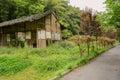 Wayside deserted ancient clay house in weeds