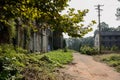 Wayside dilapidated brick buildings of abandoned 1960s` factory in weeds