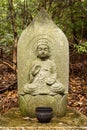 Wayside stone carved Buddha statue.