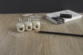 WBS acronym Work Breakdown Structure on wooden cubes. Beautiful wooden table, black background. Pencil, notepad, paper clips.