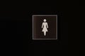 WC toilet signs on a dark black door. The indicator shows that here is the restrooms for girls