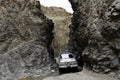 4wd car adventure driving through a crag in the Gobi desert