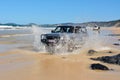 4WD Toyota car driving across a washout in Queensland, Australia.