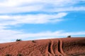 4WD trail marks on a red Sand dune under blue sky Royalty Free Stock Photo