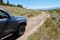 4WD vehicle driving on a narrow dirt road Royalty Free Stock Photo