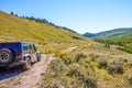 4WD vehicle driving off road through mountains Royalty Free Stock Photo