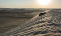 4WD vehicle driving up a sand dune in Khor Al Adaid desert in Qatar Royalty Free Stock Photo