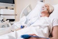 Weak ailing woman getting oxygen for recovery