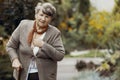 Elderly woman with walking stick during breathlessness attack Royalty Free Stock Photo