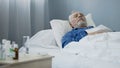 Weak male patient napping on hospital bed after taking daily dose of medication Royalty Free Stock Photo