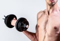 Weak man lift a weight, dumbbells, biceps, muscle, fitness. Nerd maleraising a dumbbell. Man holding dumbbell in hand