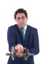 Weak man in suit lifting a weight Royalty Free Stock Photo