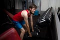 Weak man tries to lift heavy dumbbell, wants to be strong and fit. sport, motivation, strength. newbie concept in the gym Royalty Free Stock Photo