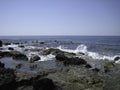 Weak waves gently wash the stones lying on the shallow bottom of the sea rocky shore in good weather