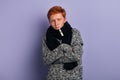 Weak young man wearing fashion sweater and scarf standing with crossed arms Royalty Free Stock Photo