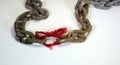 The weakest link; a massive chain where one link is replaced with a piece of red thread with frays