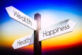 Wealth, health, happiness concept - signpost with three arrows