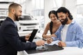 Wealthy millennial indian family buying new car in showroom Royalty Free Stock Photo