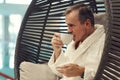 Wealthy Senior Man Enjoying Coffee in SPA Resort