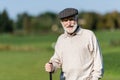 wealthy senior man in flat cap