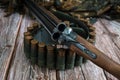 Weapons, a bandolier of ammunition, and a camouflage costume on a wooden background. Royalty Free Stock Photo