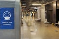 Wear face covering poster on digital display on train station during covid-19 lockdown in england uk