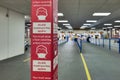 Wear face covering poster on digital display on train station during covid-19 lockdown in england uk