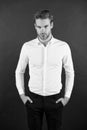 Wear it simple. White shirt and black pants. Serious man dark background. Fashion look of handsome guy. Fashion model in Royalty Free Stock Photo