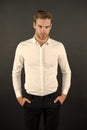 Wear it simple. White shirt and black pants. Serious man dark background. Fashion look of handsome guy. Fashion model in Royalty Free Stock Photo