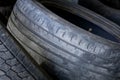 Wear and tear of old rubber car tires. Worn out treads of old rubber vehicle tire. Damaged rubbers for recycling Royalty Free Stock Photo