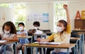 Wearing face mask to protect from covid while learning in class, answering education question and studying with students