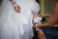 Wearing garter on leg of bride Royalty Free Stock Photo