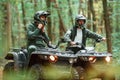 Wearing helmets. Two male atv riders is in the forest together Royalty Free Stock Photo