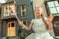 Positive long-haired girl in festive dress playing in fantastic game Royalty Free Stock Photo