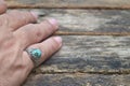 Wearing a precious silver Turquoise ring.