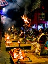 Some Brahman priest wearing red and yellow dress doing traditional ganga aarti at dasaswamedh ghat, Varanasi, Uttar Pradesh, India