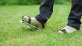 Wearing spiked lawn revitalizing aerating shoes, gardening concept Royalty Free Stock Photo