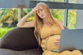 Weary pregnant woman, tired of working from home, navigates the challenges of balancing professional tasks with Royalty Free Stock Photo