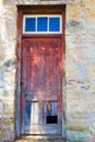 Weather beaten door of an old store room