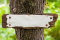 Weather-beaten old sign in the woods Royalty Free Stock Photo