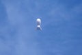A weather blimp floats in the blue sky. Royalty Free Stock Photo