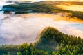 Weather change concept. Beautiful morning landscape, aerial view. Sun rises over coniferous forest Royalty Free Stock Photo