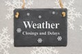 Weather closings and delays message on a chalk sign Royalty Free Stock Photo