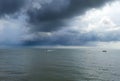 Weather cloudy and rainy on ocean storms and fishing boat on a middle sea wave. Traditional fishing boat on the river. Royalty Free Stock Photo