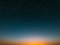 Blue bright starry sky on pink yellow sunset at sea water vawe reflection blurred light full moon moonlight  skyline  nebula natur Royalty Free Stock Photo