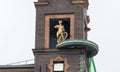 The Weather Girl, movable famous barometer on the roof of the building, girl with a bicycle and boy with umbrella Royalty Free Stock Photo