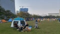 Shenzhen, China: it`s sunny and warm. Citizens relax on the park lawn, some set up tents, and the family is enjoying their leisure