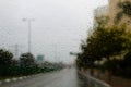 Weather in Israel: Winter rains. Abstract view to rainy road city through the car windscreen