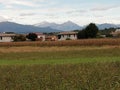 Weather over the alps in farmlands landscape in italy