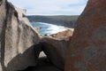 Weather sculpted granite boulder at Remarkable Rocks with beach and coastline in background